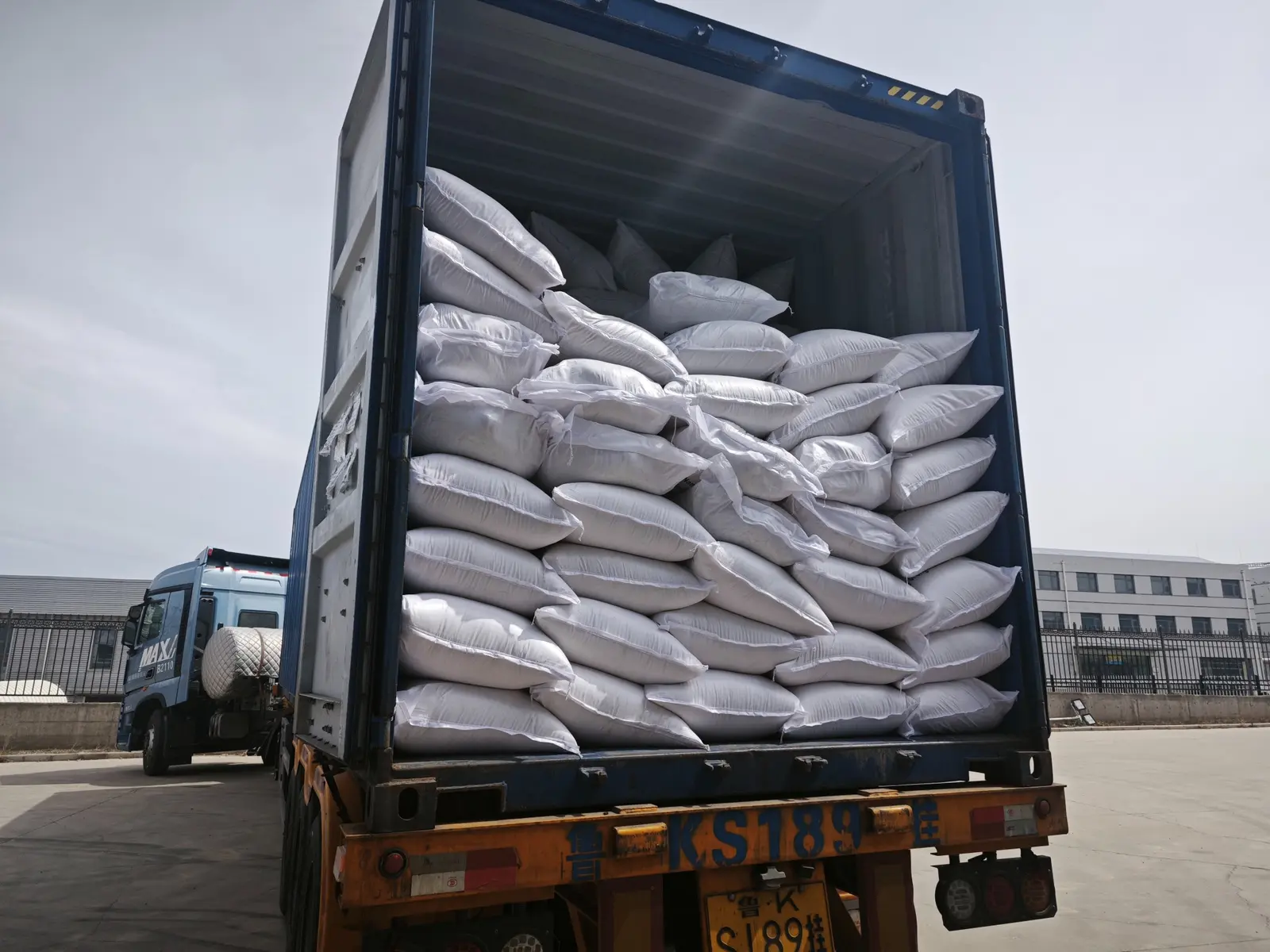 Industrial potato ingredient bags arranged inside a shipping container